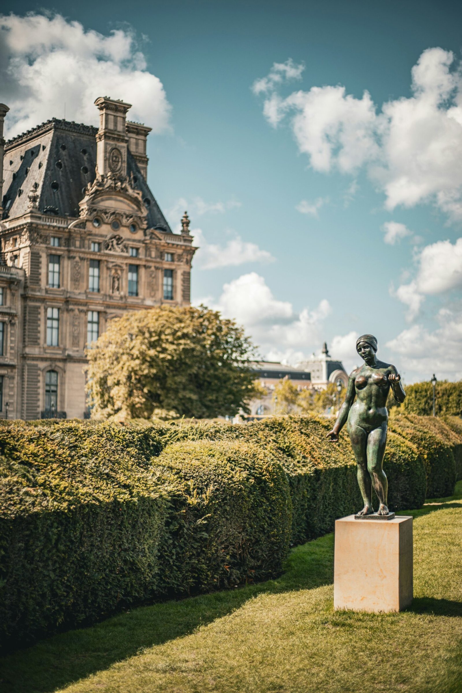 A statue of a boy in front of a building