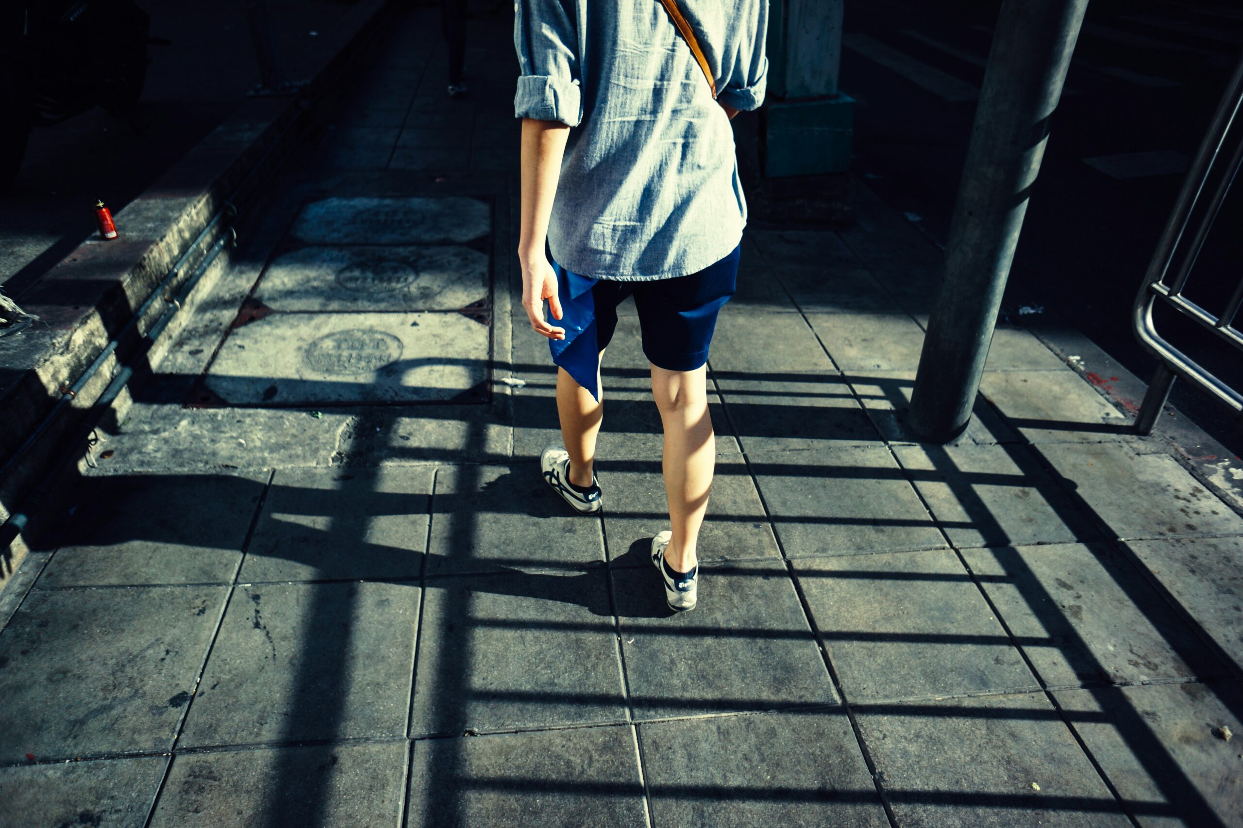 person standing on gray pavement during daytime